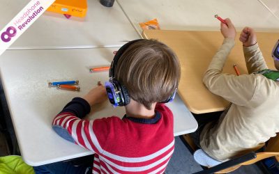 Schüler bauen mit Magneten und tragen dabei Silent Kopfhörer von Headphone Revolution auf dem Musik übertragen wird.